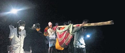 The mother and the baby being brought down the hill (Photo| Express)