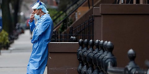 An emergency room nurse takes a break from his work at the Brooklyn Hospital Center in New York amid raging COVID cases. (File photo| AP)