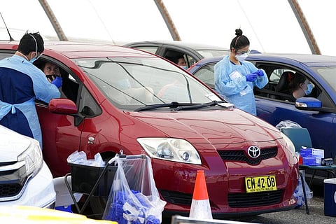 Medical staff collect COVID-19 swabs from people at a drive-though clinic in Sydney, Saturday, Dec. 25, 2021. (Photo | AP)