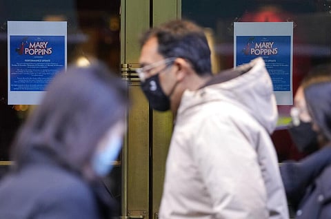 Pedestrians wearing masks against the coronavirus walk past a theater that has cancelled is performances of Mary Poppins due to COVID-19, in London. (Photo | AP)