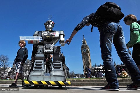 People look a mock 'killer robot' in central London on April 23, 2013 during the launching of the Campaign to Stop 'Killer Robots.' (Photo | AP)