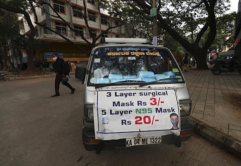 A vendor sells face masks to be used as a precaution against COVID-19 in Bengaluru, capital of the southern Indian state of Karnataka, Thursday, Dec. 2, 2021. (Photo | AP)