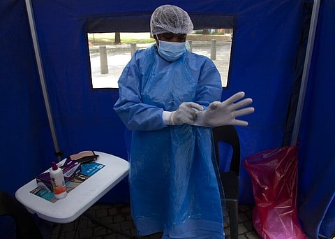 A healthcare worker prepares to test a person for COVID-19 at a facility in Soweto, South Africa, Wednesday Dec. 2, 2021. (Photo | AP)