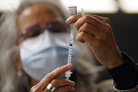 Dr. Manjul Shukla transfers Pfizer COVID-19 vaccine into a syringe, Thursday, Dec. 2, 2021, at a mobile vaccination clinic in Worcester, Mass. (Photo | AP)