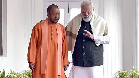 PM Narendra Modi (R) interacts with Uttar Pradesh CM Yogi Adityanath.