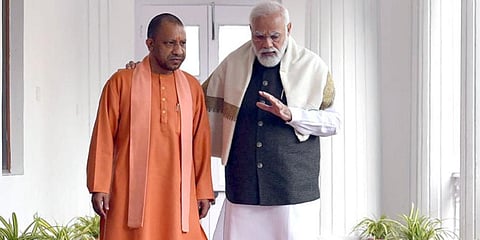 Uttar Pradesh Chief Minister Yogi Adityanath along with Prime Minister Narendra Modi during a roadshow for the Lok Sabha elections, in Varanasi.