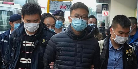 Editor of Stand News Patrick Lam, center, is arrested by police officers in Hong Kong, Wednesday, Dec. 29, 2021. (Photo | AP)