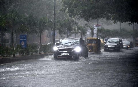 Vehicles wade through rain water at GN Chetty road in Chennai. (Photo | Martin Louis, EPS)