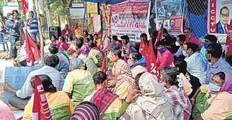 Workers on the 29th day of their protest outside the ITI premises