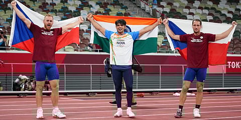 Neeraj Chopra, of India, center, celebrates after winning the gold medal with silver medalist Jakub Vadlejch, of the Czech Republic, and bronze medalist Vitezslav Vesely. (Photo | AP)