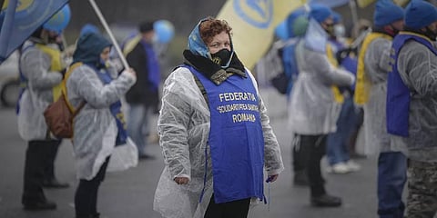 Health workers take part in a protest outside the government building in Bucharest, Romania. (Photo | AP)