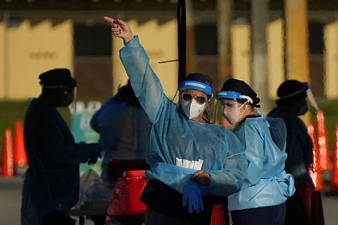 A health care worker directs drivers to other lanes at a drive-up COVID-19 testing center at Tropical Park, Wednesday, Dec. 29, 2021, in Miami. (Photo | AP)