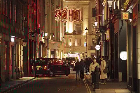 People walk in the street in Soho in London as British Prime Minister Boris Johnson has resisted implementing new restrictions on social interactions during the holiday season. (Photo | AP)