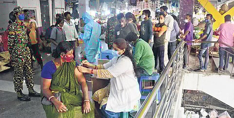 A health worker administers Covid-19 vaccine to a woman in KR Market, Bengaluru,   on Friday |  Shriram BN