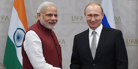 PM Narendra Modi (L) interacts with Russia President Vladimir Putin (File Photo | AP)