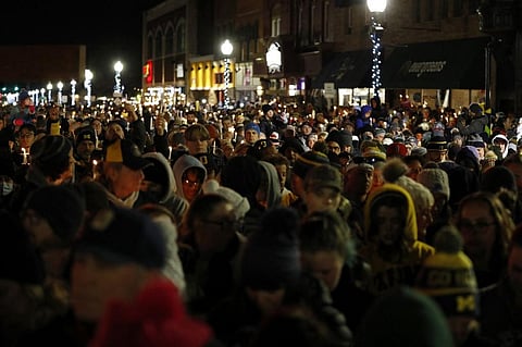 People gather for a candle light vigil for the victims of the Oxford High School shooting in downtown in Oxford, Michigan on December 3, 2021. (Photo | AFP)