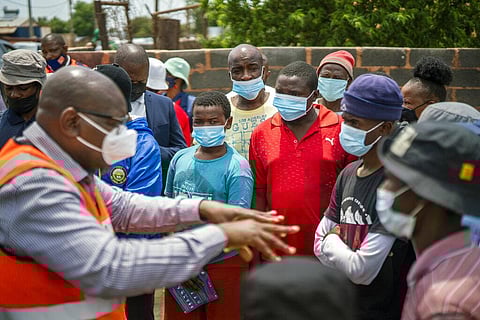Residents listen to Gauteng Province Premier David Makhura in Lawley, South Africa, Friday Dec. 3, 2021. (Photo | AP)