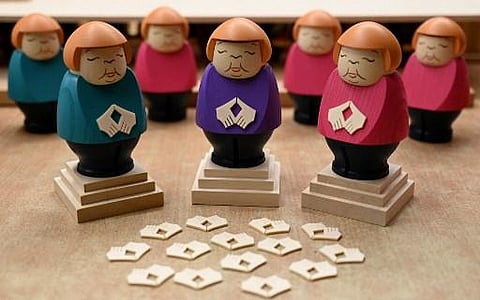 Picture taken on August 20, 2021 shows incense smokers featuring German Chancellor Angela Merkel making her typical 'rhombus' hand gesture. (Photo | AFP)