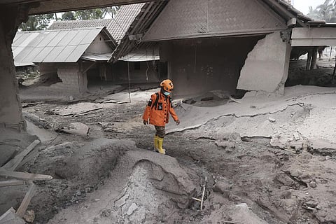 A rescuer walks in an area hit by the eruption of Mount Semeru in Lumajang district, East Java province, Indonesia. (Photo | AP)