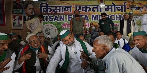 An elderly farmer talks to farmer leader Rakesh Tikait, centre, during a rally at Ghazipur, on the outskirts of New Delhi. (Photo | AP)