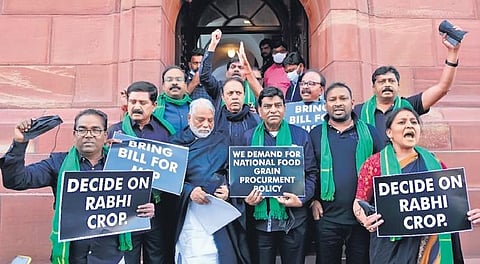TRS MPs shout slogans in front of Parliament building in New Delhi on Tuesday, demanding justice for paddy farmers