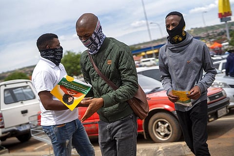 A man looks at a pamphlet distributed by Funeral Parlours Association in Soweto, South Africa, Tuesday Dec. 7, 2021. (Photo | AP)