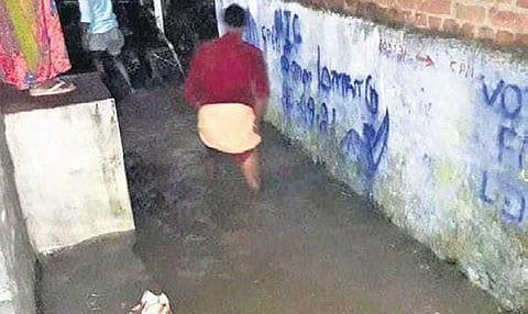 Residents wade through water  which entered houses and shops  in Vallakkadavu area on  Monday night | Express
