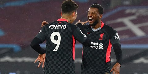 Liverpool's Georginio Wijnaldum (R) celebrates after scoring his side's third goal during the EPL match against West Ham at the London Stadium in London. (Photo | AP)