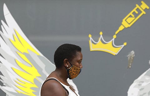 A woman wears a mask to protect against coronavirus. (Photo | AP)