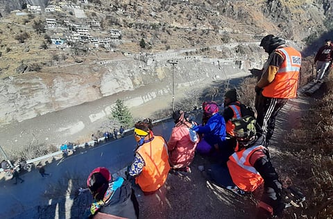 People watch as water level of Rishi Ganga river rises at chamoli in Joshimath, Uttrakhand on Thursday.  (Photo | EPS/Shekhar Yadav)