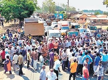 Locals stage a protest on NH-363, after the death of a girl in a mishap, bringing traffic to a standstill at Moranchapalli