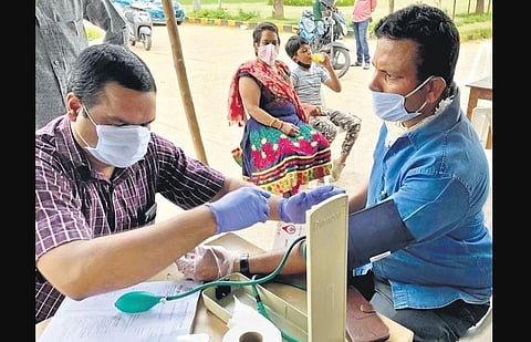 Deputy Tahsildar M Raghunandhan of the Civil Supplies Department gets his BP checked during one of his anti-tobacco campaigns.
