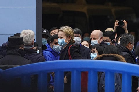 The World Health Organization team is briefed outside of the Huanan Seafood Market on the third day of their field visit in Wuhan, China. (File Photo | AP)