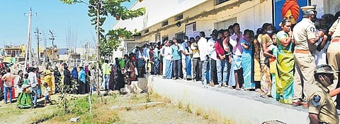 People stand in a long queue to cast their vote at a polling station at Gurramkonda village in Chittoor district on Saturday | EXPRESS