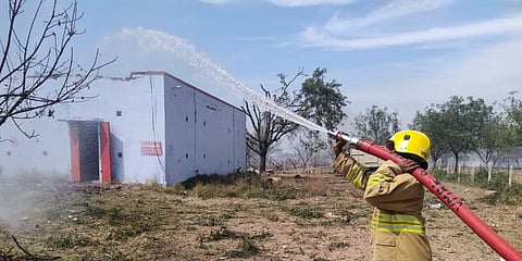 A firefighter at work following the blast that was triggered at a cracker unit at Achankulam village near Sattur in Virudhunagar district. (Photo | EPS)
