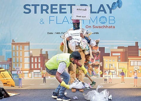 BBMP staffers perform a street play on the garbage menace and the importance of waste management, on Church Street in Bengaluru on Sunday | meghana sastry