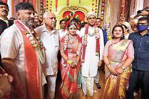 CM B S Yediyurappa poses with the bride Aisshwarya, groom Amartya and KPCC president D K Shivakumar and his wife Usha in Bengaluru on Sunday