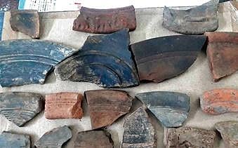 The material evidences were found after digging four ft below a trench on the mound.