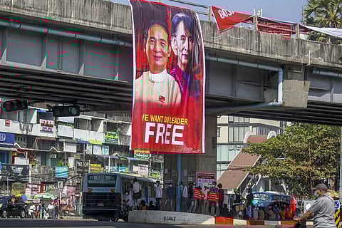 Pictures of detained Myanmar President Win Myint and leader Aung San Suu Kyi are displayed at an intersection against the military coup in Yangon, Myanmar. (Photo | AP)