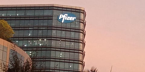 The logo of pharmaceutical giant Pfizer lights up outside its office in Mumbai. (Photo | Debdutta Mitra, EPS)