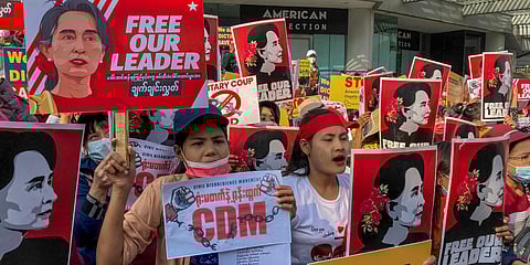Demonstrators display images of detained Myanmar leader Aung San Suu Kyi during a protest against the military coup in Yangon. (Photo| AP)