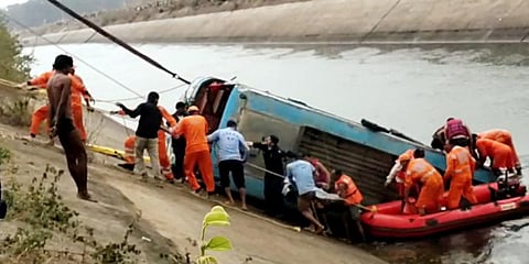 NDRF team carries out a rescue operation after an overcrowded bus plunged into a canal, in Sidhi. (Photo | ANI)