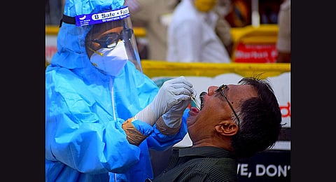 Health worker collects the swab sample of a person for Covid testing .(File Photo | EPS)
