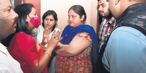 Hyderabad Mayor Gadwal Vijayalakshmi speaks to residents of First Lancer after boulders rolled onto their locality from a nearby hill.