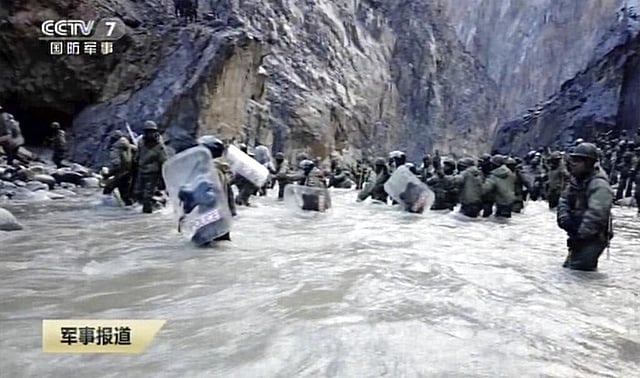 Clearly another work of the Chinese propaganda machinery, the Chinese soldiers are seen trying to pacify the aggressively advancing Indian soldiers wearing riot gear and batons before revealing the images of the four PLA personnel killed in action. (Photo | AP)