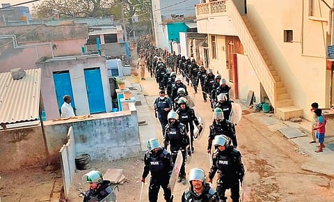 Police conduct a flag march in a sensitive area in Kadapa on Thursday ahead of the panchayat elections scheduled for Sunday I Express
