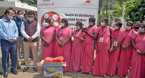 Health and Education Minister Dr K Sudhakar distributes ‘Health and Hygiene kits’ to ASHA workers on Thursday in Bengaluru. (Photo | Meghana Sastry, EPS)