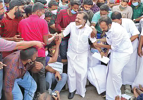 PSC civil police officer job aspirants help Opposition Leader Ramesh Chennithala get up, after he joined them in their protest in front of the Secretariat on Sunday  | B P Deepu
