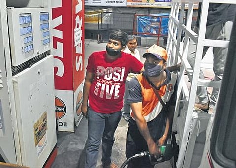 A man has a worried look on his face as he refuels his vehicle in Hyderabad on Sunday. (Photo | EPS/S Senbagapandiyan)