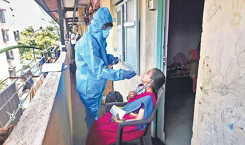 A health worker takes an RT-PCR test in Dharavi in Mumbai. (File Photo | PTI)